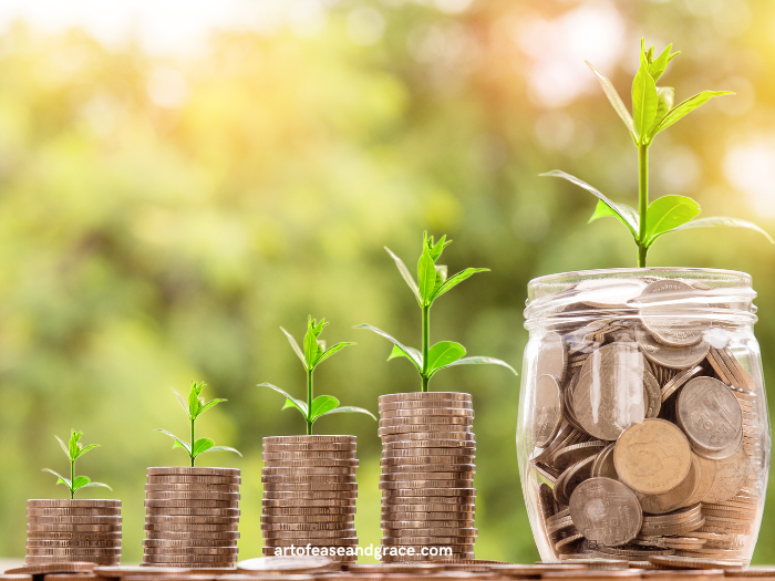 Four stacks of coins increasing in height stand next to a larger jar of coins. A plant appears to be growing out of each stack. The background is green and out of focus and appears to be a forest.